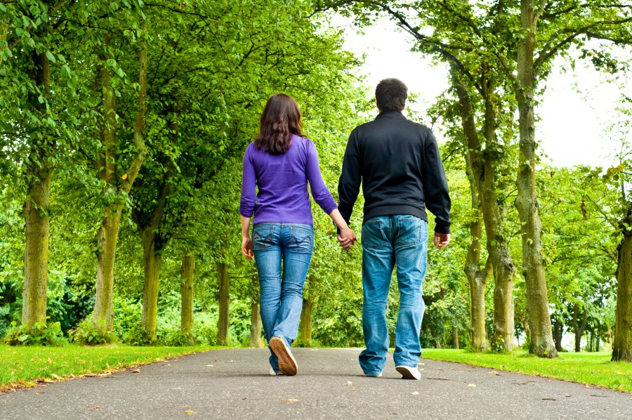 couple walking a path in a park